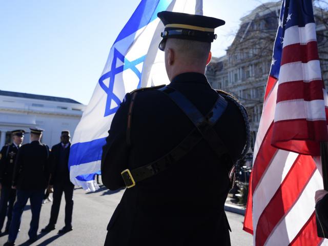 Flags are prepared for the arrival of Israeli Prime Minister Benjamin Netanyahu outside the East Wing of the White House, Tuesday, Feb. 4, 2025, in Washington. (AP Photo/Alex Brandon)