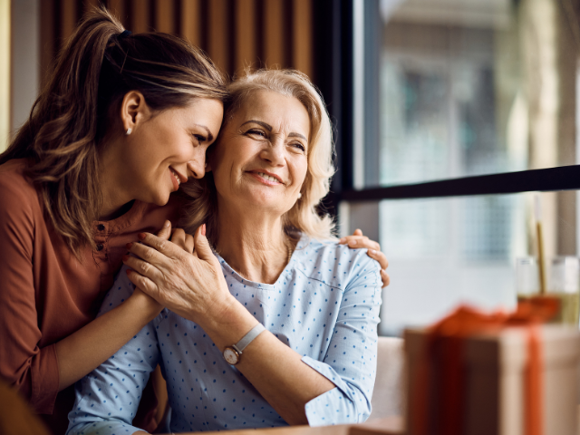 adult daughter giving a hug to her mother