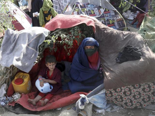 Displaced Afghans from northern provinces take refuge in a public park Kabul, Afghanistan, Friday, Aug. 13, 2021. (AP Photo/Rahmat Gul)