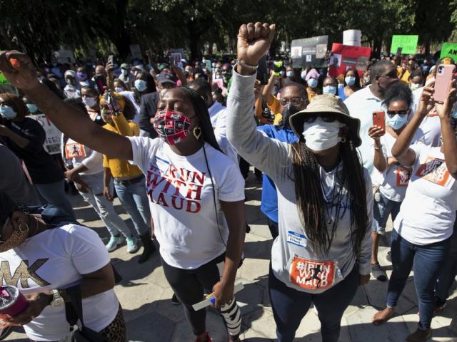 In this Friday, May 8, 2020, file photo, people hold a rally to protest the shooting of Ahmaud Arbery, an unarmed black man in Brunswick Ga (AP Photo/John Bazemore, File)