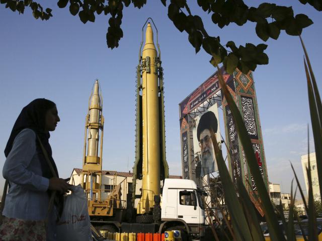 FILE-- In this Sept. 24, 2017 file photo, surface-to-surface missiles and a portrait of the Iranian Supreme Leader Ayatollah Ali Khamenei are displayed by the Revolutionary Guard in an exhibition. (AP Photo)