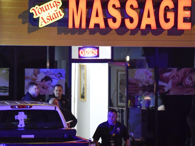  Authorities investigate a fatal shooting at a massage parlor, late Tuesday, March 16, 2021, in Acworth, Ga. (AP Photo/Mike Stewart)