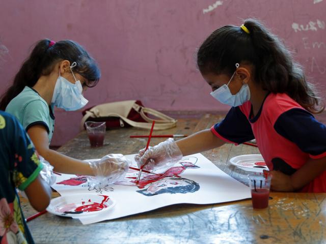 Students paint during an UNRWA summer camp at the Beach Preparatory School for girls, in the Shati refugee camp, Sunday, July 4, 2021. According to UNRWA it has started summer camps for 150,000 children in the Gaza Strip. (AP Photo/Adel Hana)