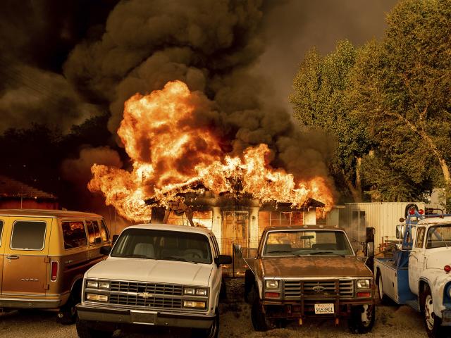 Flames consume a home as the Sugar Fire, part of the Beckwourth Complex Fire, tears through Doyle, Calif., on Saturday, July 10, 2021. (AP Photo/Noah Berger)