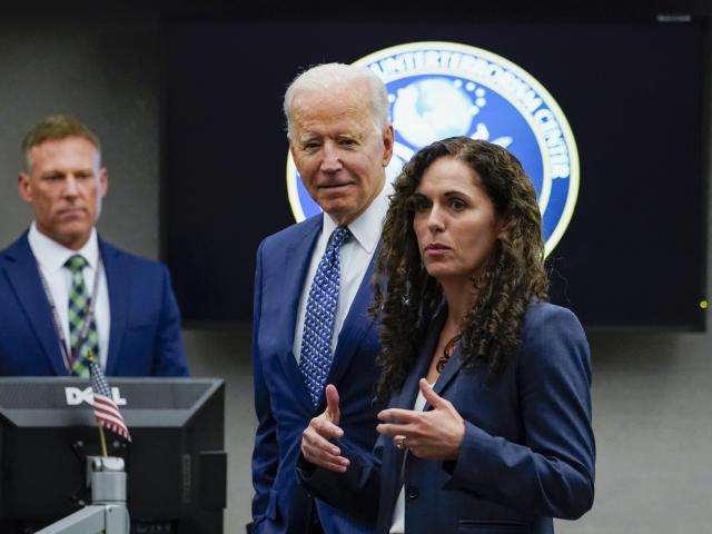 President Joe Biden listens as Director of the National Counterterrorism Center Christine Abizaid speaks during a visit to the Office of the Director of National Intelligence in McLean, Va., Tuesday, July 27, 2021. (AP Photo/Susan Walsh)