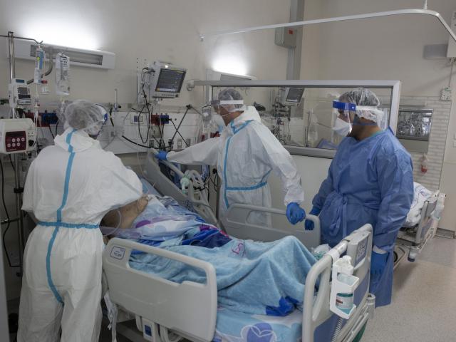 Medical professionals tend to an elderly man after they took him off of a breathing machine in the coronavirus ward at Barzilai Medical Center in Ashkelon, Israel, Thursday, Aug. 26, 2021. (AP Photo/Maya Alleruzzo)