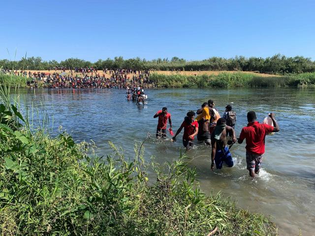 Migrants find an alternate place to cross from Mexico to the United States after access to a dam was closed, Sunday, Sept. 19, 2021, in Ciudad Acuña, Mexico.(AP Photo/Sarah Blake Morgan)