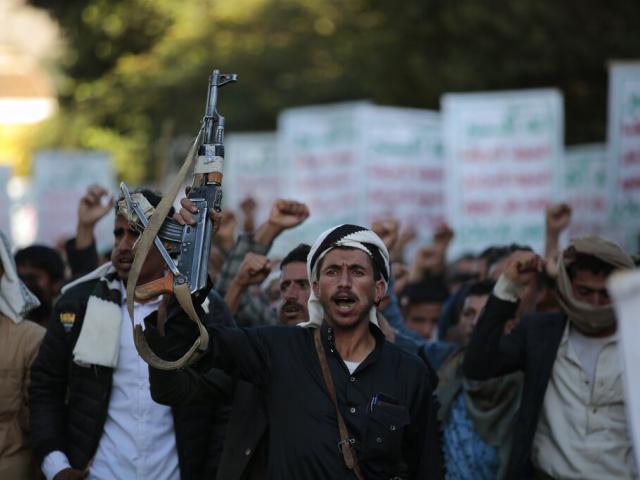 A Houthi supporter holds a weapon as he chants slogans during a rally against the U.S. support to the Saudi-led coalition in Sanaa, Yemen, Monday, Nov. 22, 2021. (AP Photo/Hani Mohammed)