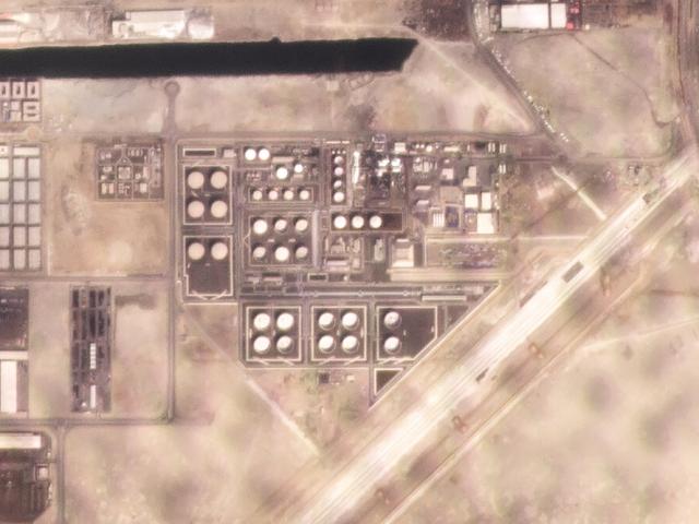In this satellite image provided by Planet Labs PBC, white fire suppressing foam is seen after an attack on an Abu Dhabi National Oil Co. fuel depot. (Planet Labs PBC via AP)