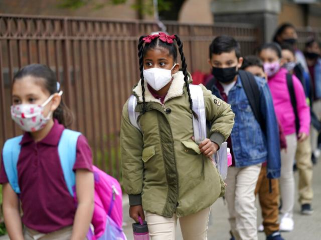 Students line up to enter Christa McAuliffe School in Jersey City, N.J., April 29, 2021. New Jersey Gov. Phil Murphy will end a statewide mask mandate to protect against COVID-19 in schools and child care centers, his office said Monday, Feb 7, 2022. (AP)