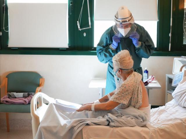A patient is checked by a doctor at a COVID-19 sub-intensive care unit of the Tor Vergata Hospital, in Rome, Monday, Feb. 7, 2022. (AP Photo/Gregorio Borgia)