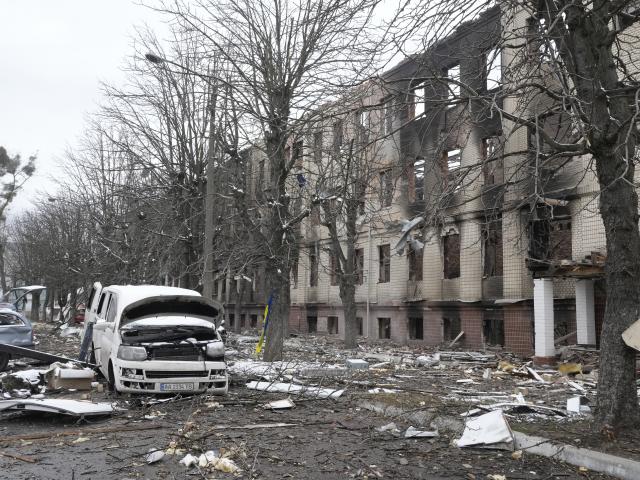 Damaged cars and a destroyed accommodation building in Brovary, outside Kyiv, Ukraine, Tuesday, March 1, 2022. (AP Photo/Efrem Lukatsky)