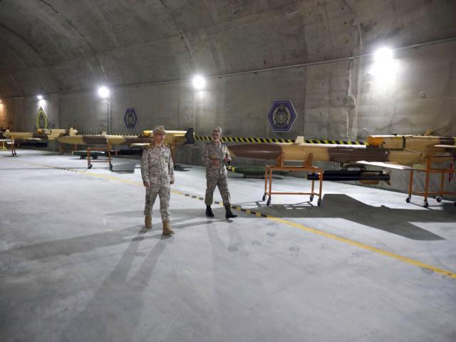 In this photo released on Saturday, May 28, 2022 by website of the Iranian Army, Iranian officials visit n underground drone base tunnel of the Army in the heart of the country&#039;s western Zagros Mountains. (Iranian Army via AP)
