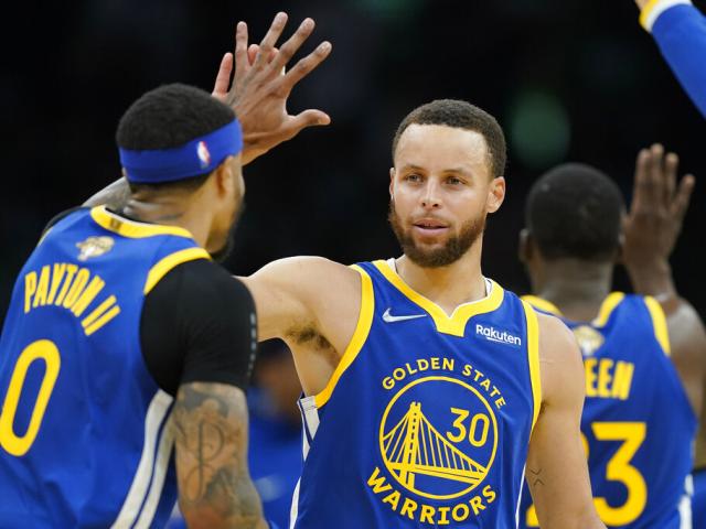 Golden State Warriors guard Stephen Curry (30) high fives Golden State Warriors guard Gary Payton II (0) during the second quarter of Game 6 of basketball&#039;s NBA Finals against the Boston Celtics, Thursday, June 16, 2022, in Boston. (AP Photo/Steven Senne)
