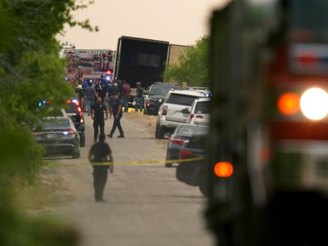 Body bags lie at the scene where a tractor trailer with multiple dead bodies was discovered, Monday, June 27, 2022, in San Antonio. (AP Photo/Eric Gay)