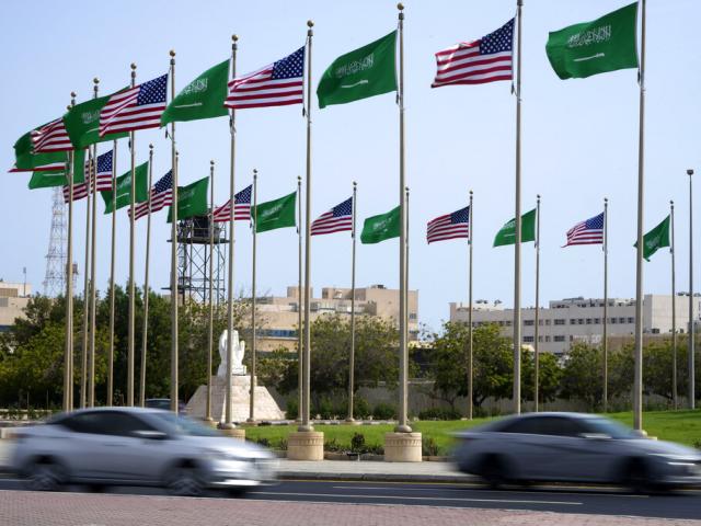 Vehicles drive past American and Saudi Arabian flags prior to a visit by U. S. President Joe Biden, at a square in Jeddah, Saudi Arabia, Thursday, July 14, 2022. (AP Photo/Amr Nabil)