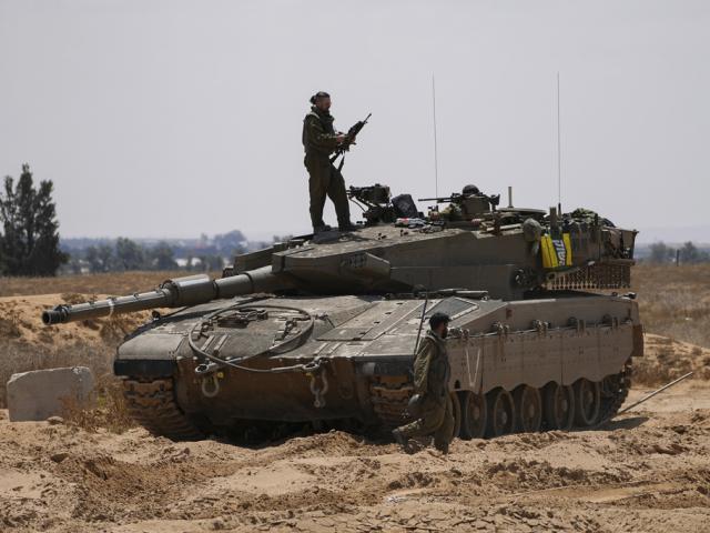 Israeli soldiers are seen near the border with the Gaza Strip, in southern Israel, Tuesday, May 7, 2024. (AP Photo/Tsafrir Abayov)
