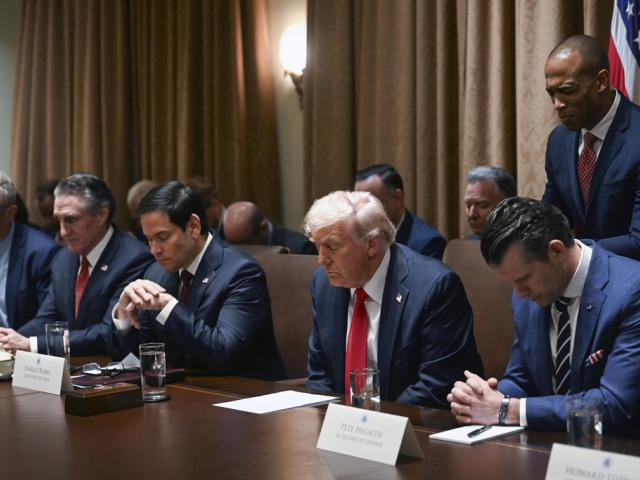 President Donald Trump prays as he holds his first Cabinet meeting at the White House in Washington, Wednesday, Feb. 26, 2025. (Pool via AP)