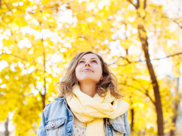 yellow leaves on trees and woman walking