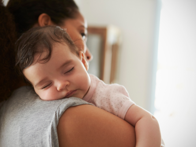 baby resting on mother