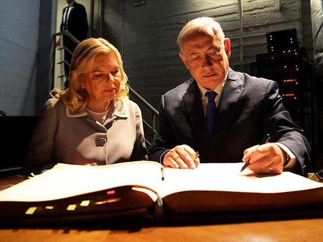 Israeli Prime Minister Benjamin Netanyahu and his Wife, Sara, Sign the Visitor&#039;s Book at AMIA, Photo, AP/GPO