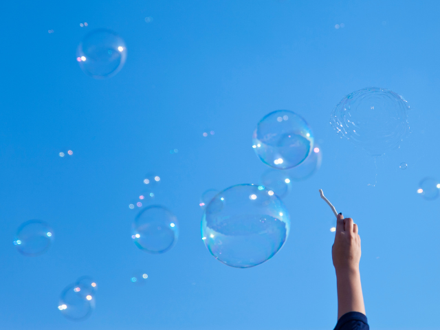 person making lots of bubbles in the sky