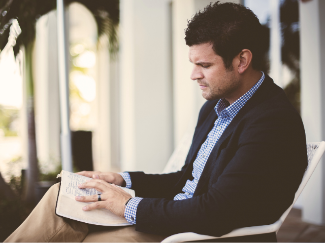 Businessman reading a Bible