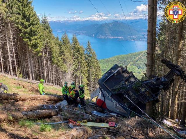 Rescuers at the wreckage of a cable car after it collapsed near the summit of the Stresa-Mottarone line in the Piedmont region, northern Italy. (Soccorso Alpino e Speleologico Piemontese via AP)