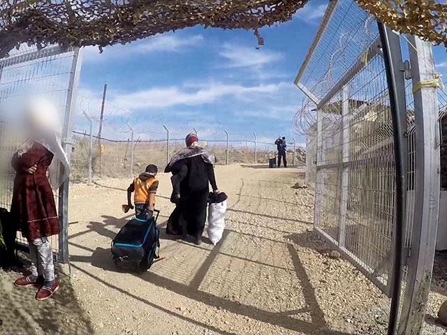 Syrians Exit Security to Enter Camp Ichay, Photo, CBN News Syrians Exit Security to Enter Camp Ichay, Photo, CBN News