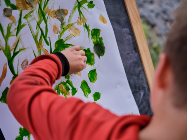 child painting on a canvas