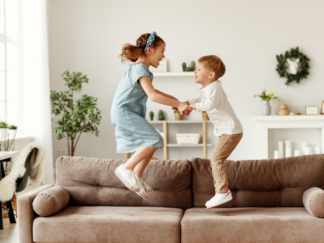 children jumping on couch