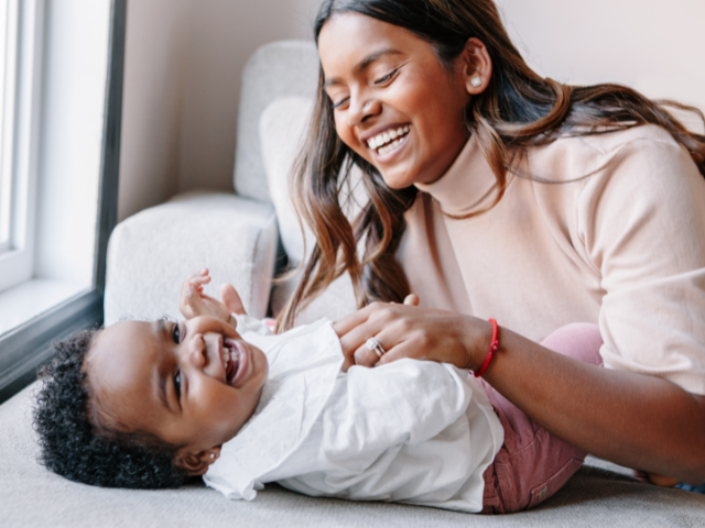 mom tickling baby