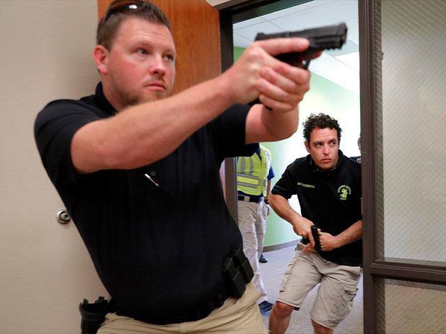 Trainees Chris Graves, left, and Bryan Hetherington, right, participate in a security training session at Fellowship of the Parks campus in Haslet, Texas. (AP Photo/Tony Gutierrez)