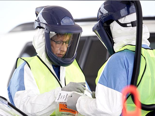 Nurses in protective gear handle a test for the coronavirus at a drive-thru testing location at Bryant Health&#039;s LifePointe campus in Lincoln, Neb., Tuesday, March 24, 2020. (AP Photo)