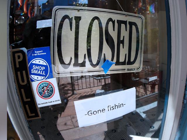 A closed sign hangs in the door of The Market, a long-time restaurant and food store located in Larimer Square, that has closed because of the new coronavirus, Thursday, June 18, 2020, in downtown Denver. (AP Photo/David Zalubowski)