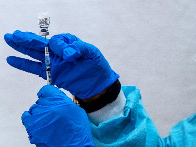 A pharmacist fills a syringe with the Pfizer-BioNTech COVID-19 Vaccine at a pop-up COVID-19 vaccination site (AP Photo/Mary Altaffer)