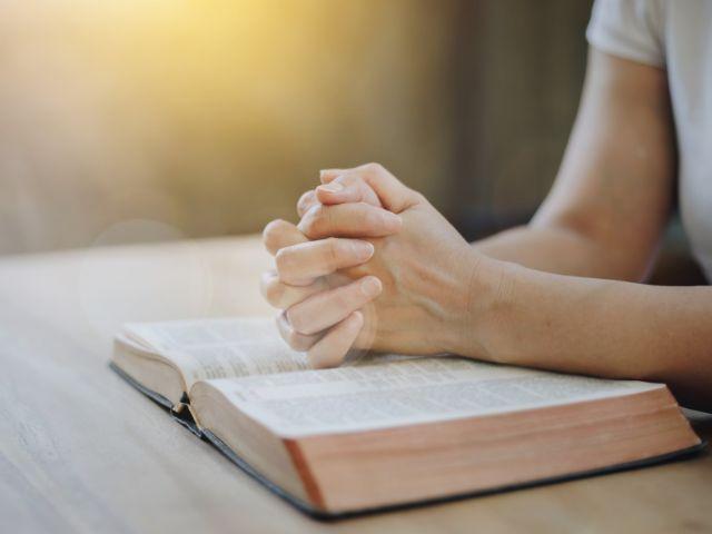 bible hands praying