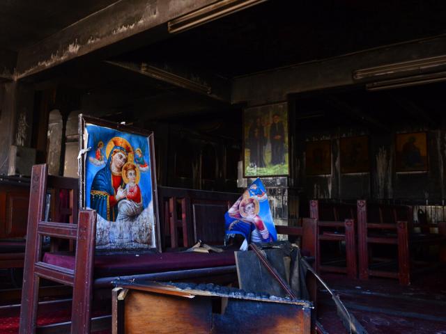 Burned furniture and religious imagery at the site of a fire inside the Abu Sefein Coptic church that killed at least 40 people in the densely populated neighborhood of Imbaba, Cairo Egypt, Sunday, Aug. 14, 2022. (AP Photo/Tarek Wajeh)
