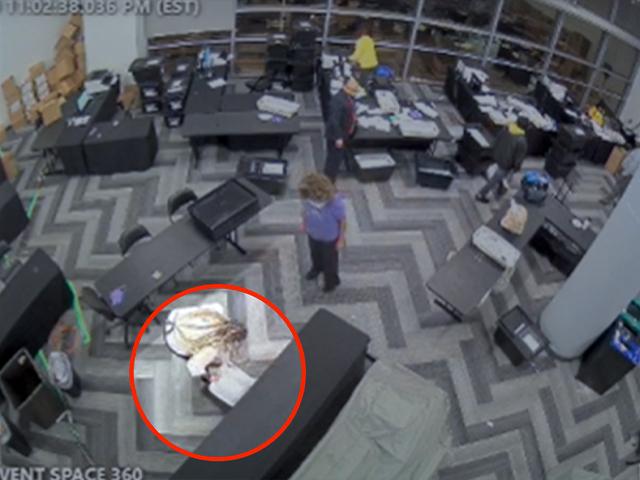 Surveillance video from the State Farm Arena in Fulton, GA shows suitcases of ballots pulled from hiding late at night (Image: Screen Capture)