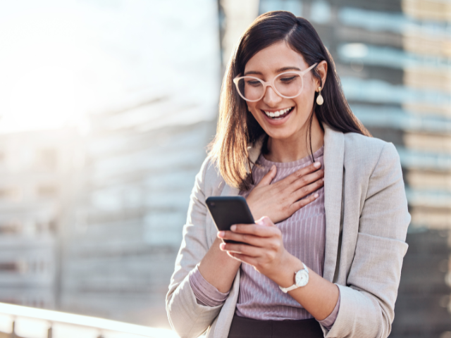 happy woman looking at cellphone