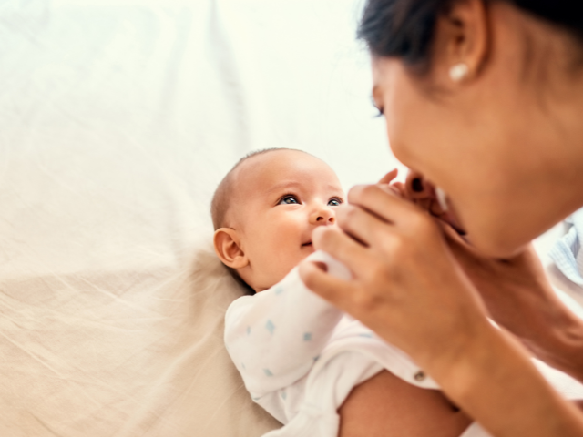 Happy mother with infant baby