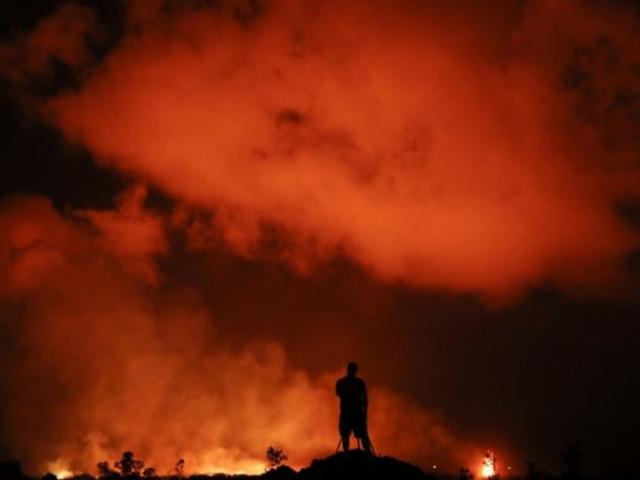 Peter Vance, 24, photographs lava erupting in the Leilani Estates subdivision near Pahoa, Hawaii Friday, May 18, 2018. AP Photo. Peter Vance, 24, photographs lava erupting in the Leilani Estates subdivision near Pahoa, Hawaii Friday, May 18, 2018. AP Photo.