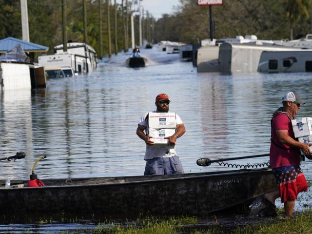 Meals, diapers, and water being delivered to flooded areas along the Peace River, in the aftermath of Hurricane Ian in Arcadia, Fla., Oct. 3, 2022. (AP Photo/Gerald Herbert)