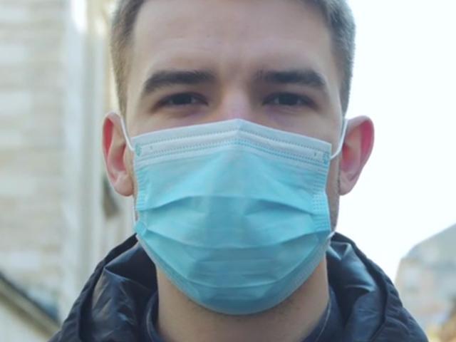Close up of young man wearing mask