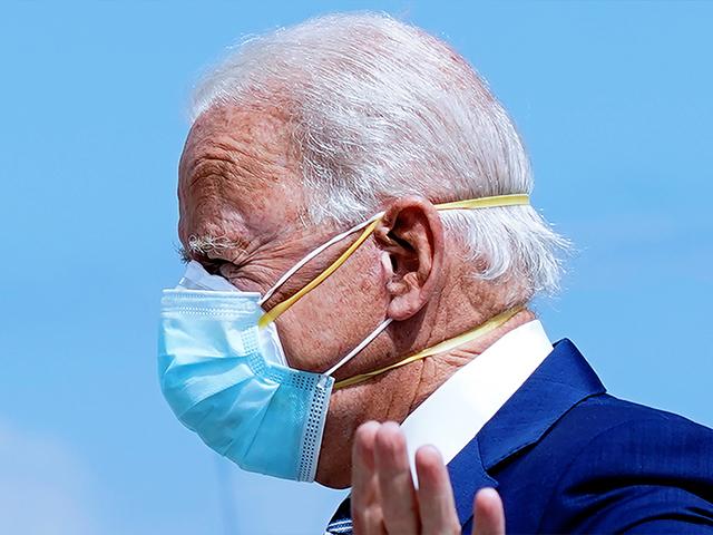Democratic presidential candidate former Vice President Joe Biden wears two face masks as he arrives at Fort Lauderdale-Hollywood International Airport, in Fla., Oct. 13, 2020. (AP Photo/Carolyn Kaster)