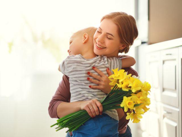 mother son hug with flowers