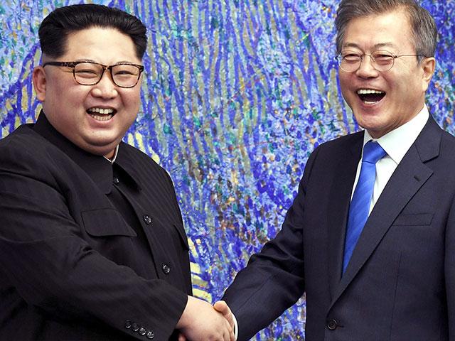 North Korean leader Kim Jong Un Shakes Hands with South Korean President Moon Jae-in, Photo, AP