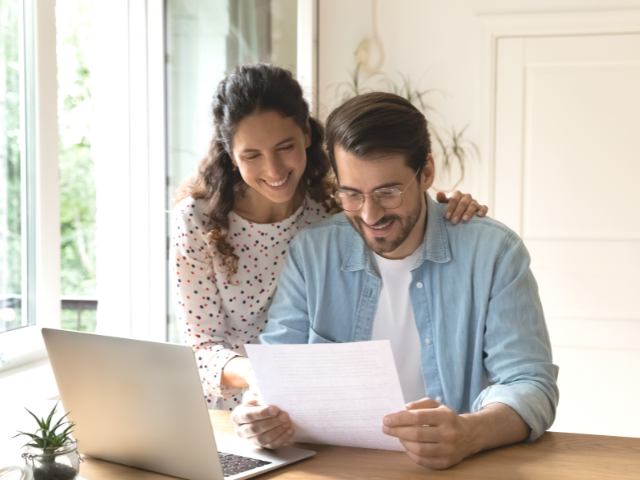 happy couple using a laptop computer