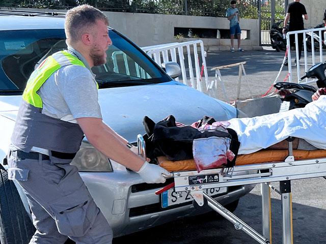 A Civil Defense first-responder carries a wounded man whose handheld pager exploded at al-Zahraa hospital in Beirut, Lebanon, Tuesday, Sept. 17, 2024. (AP Photo/Hussein Malla)