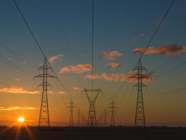 Power pylons at sunset. Unsplash.